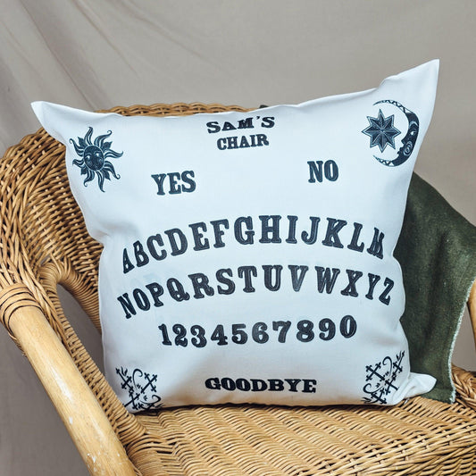 Personalized cushion with an intricate Ouija board design and the text "Name's Chair," featuring a spooky Halloween theme.