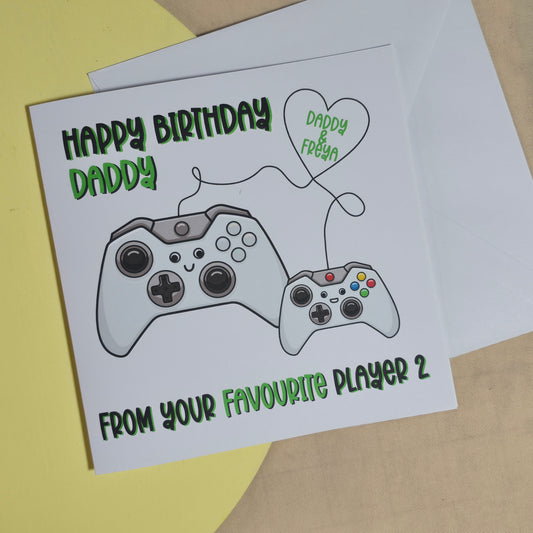 Greeting card with a gaming controller illustration and text on a yellow and beige background