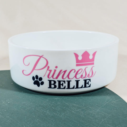 Personalised pet bowl with the text 'Princess Name' and a crown design. Available in small, medium, and large sizes, perfect for dogs or cats. Matching pet mats available.