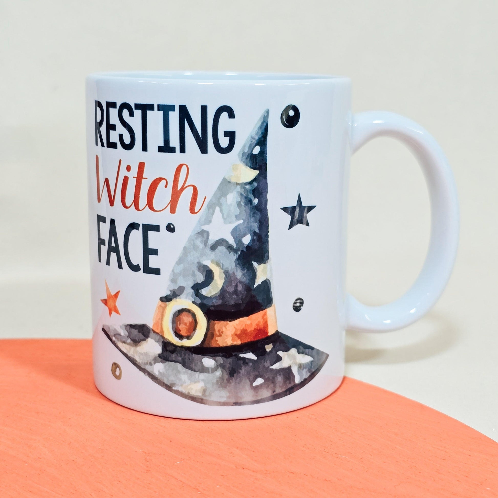 White Halloween mug with "Resting Witch Face" text and a witch’s hat design, available in 10oz, 15oz, and travel mug sizes.