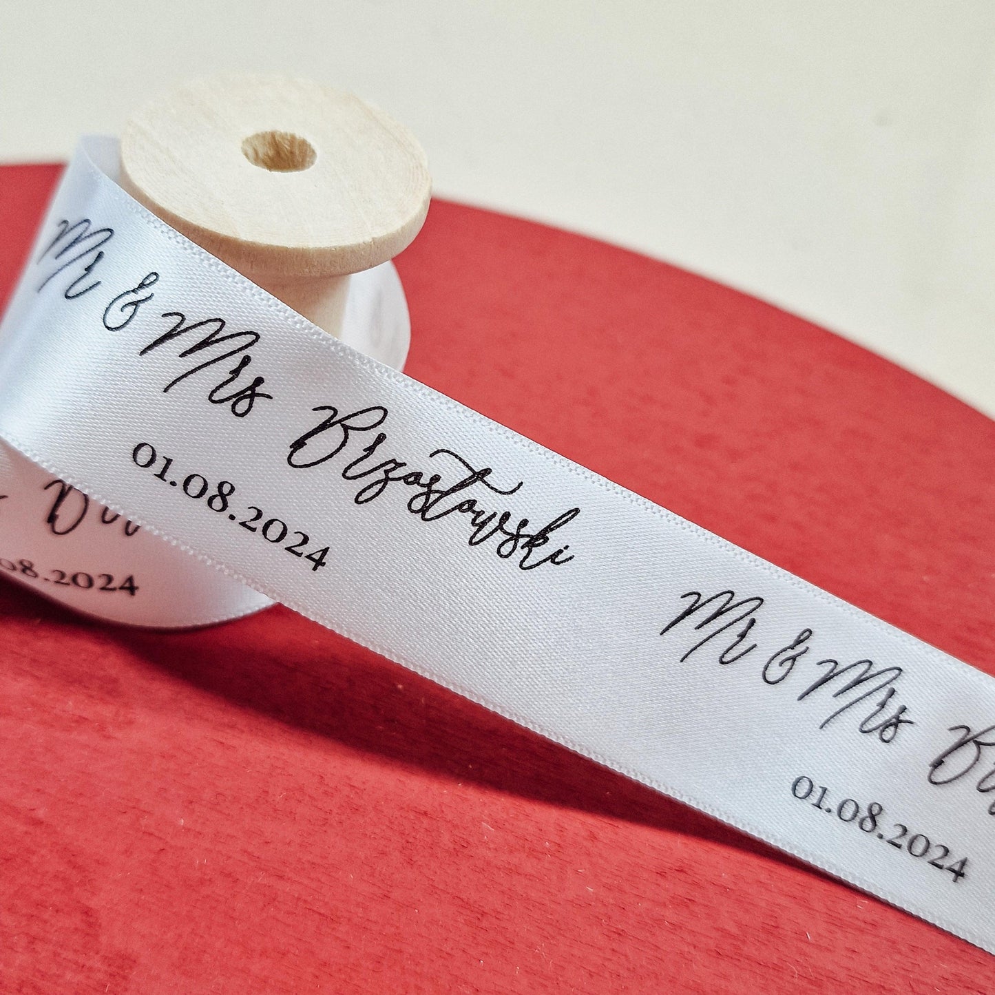 Custom wedding ribbon printed with "Mr & Mrs [Name]" and wedding date. 25mm wide, available in various colours, with options for "Mr & Mr," "Mrs & Mrs," and other titles.