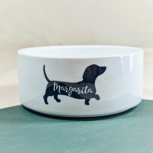 Personalised pet bowl featuring a dachshund silhouette with the dog's name printed inside. Available in small, medium, and large sizes. Perfect for dachshund lovers.