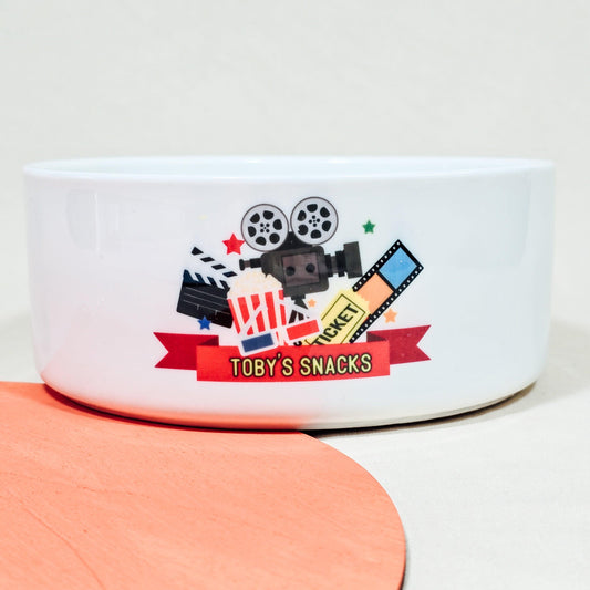 A large ceramic snack bowl personalised with "[Name]'s Snacks" in bold letters, ideal for serving snacks like popcorn or sweets during movie nights or parties.

