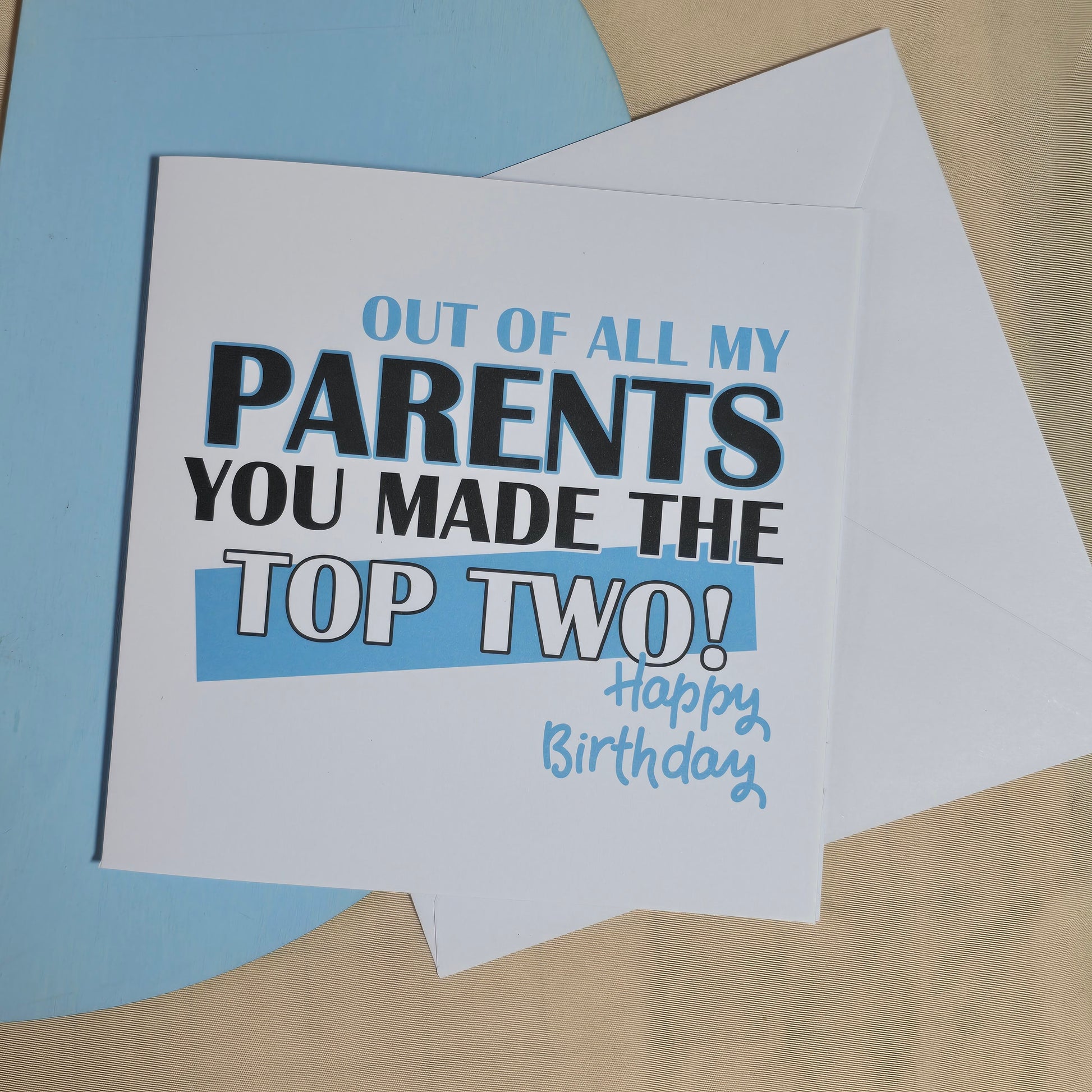 Birthday card with humorous text on a beige and blue background